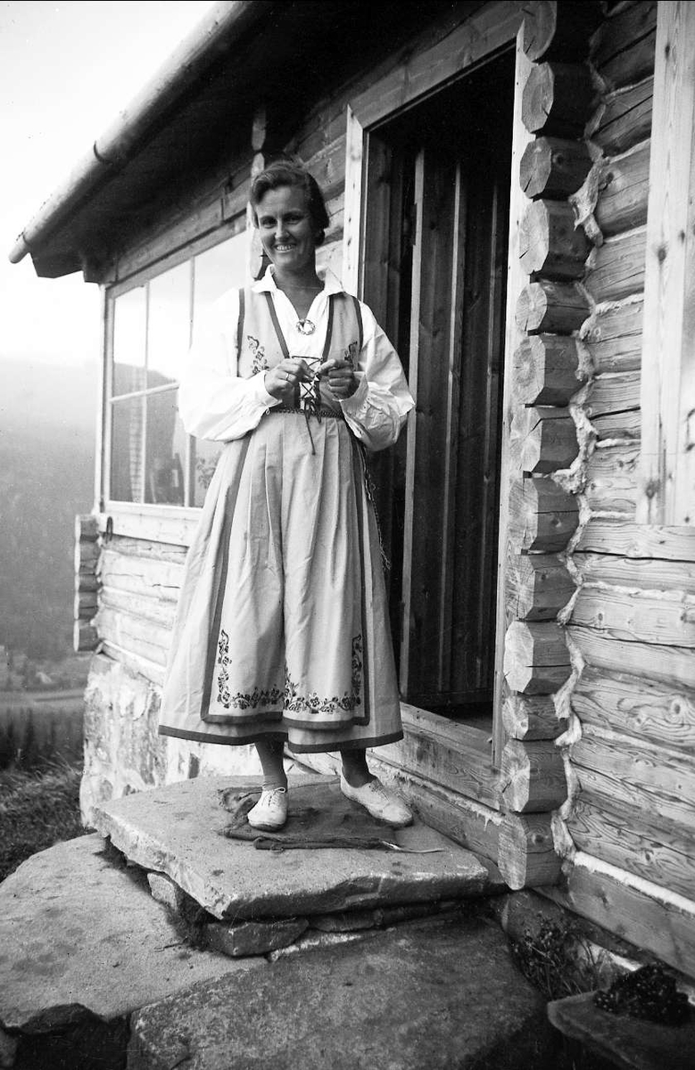 Ligardshaugen 1940. Dordi Arentz i en bunadliknende drakt står på trappa.