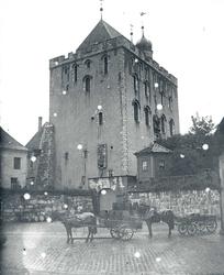 Rosenkrantstårnet i Bergen. To hestekjøretøy, et med tønner,