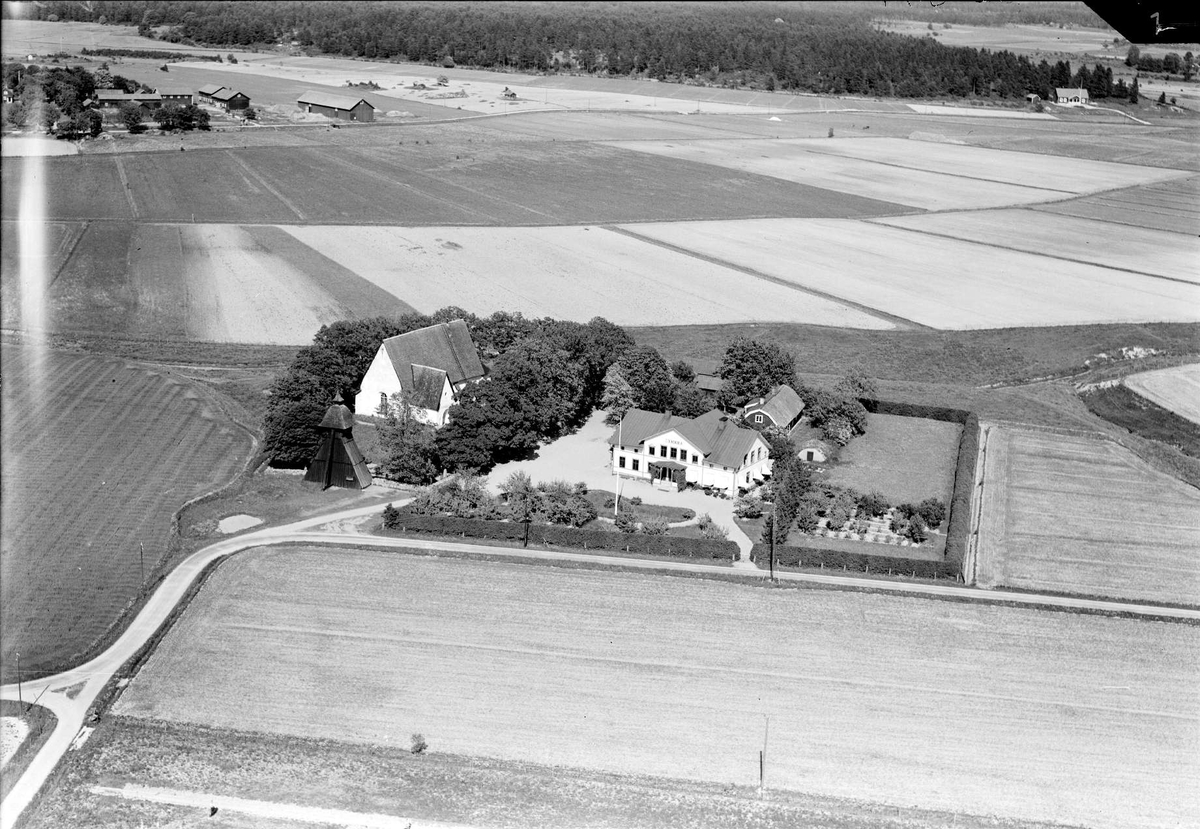 Flygfoto över Långtora kyrka med omgivande odlingslandskap, Långtora socken, Uppland 1936