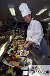 Kokk sørger for at matserveringen ser delikat ut i kantinen 