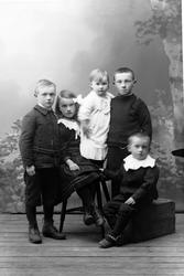 Studioportrett av fem barn i helfigur.