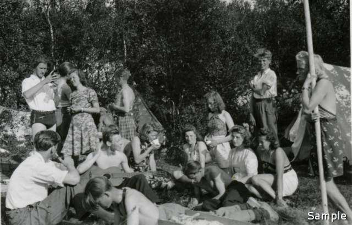 Medlemmer av NGU-laget Liv fra Narvik på Harstaleira i Hestvika 1943. (-44?)Midt i bildet med kruset: Jorun Leiknes. Helt til høyre sitter Paula Furunes. Gutten midt i bildet med skjørt er Ola Dahl. I forkant til venstre sitter Harry Svein Hjelle. 
