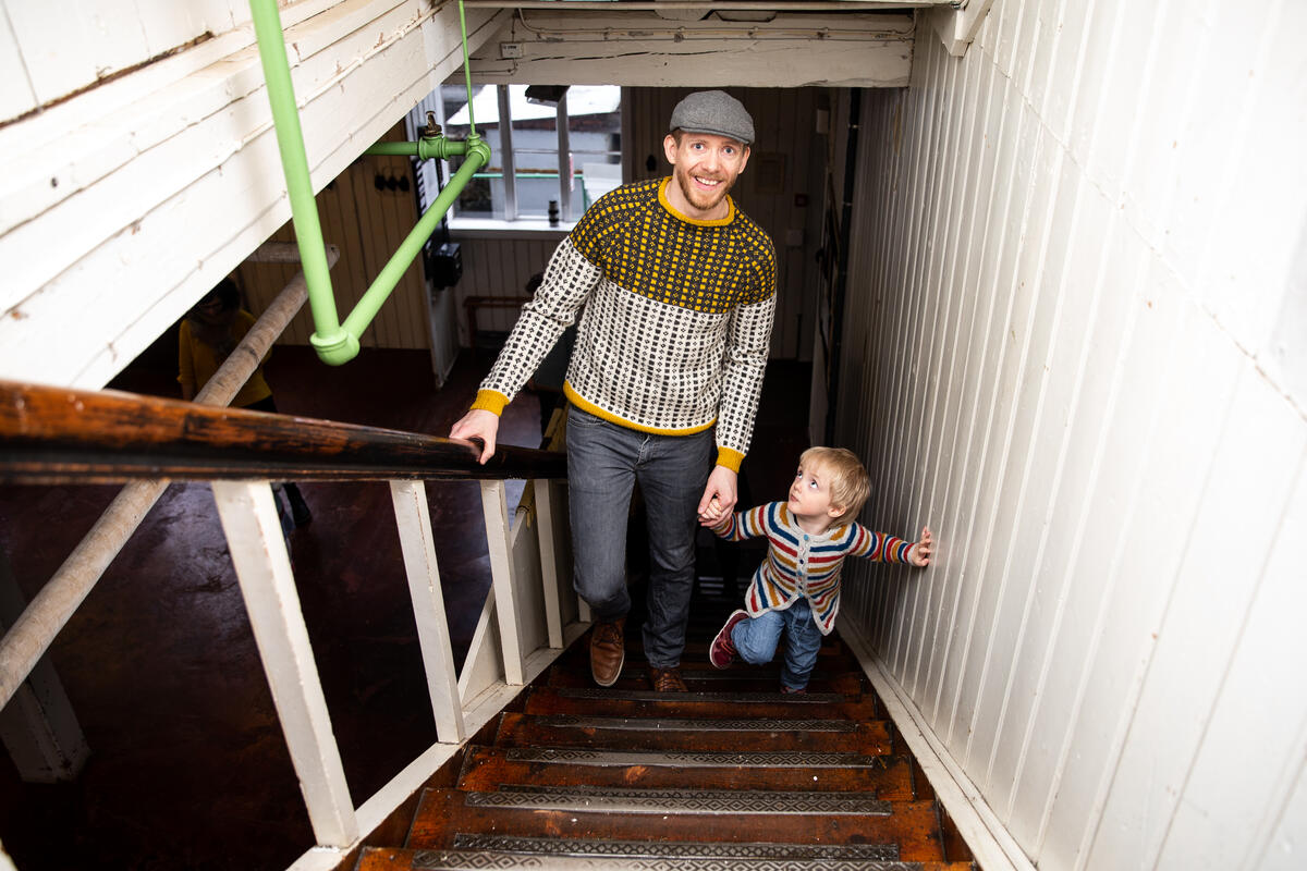 man and child walking up stairs in a former textile mill