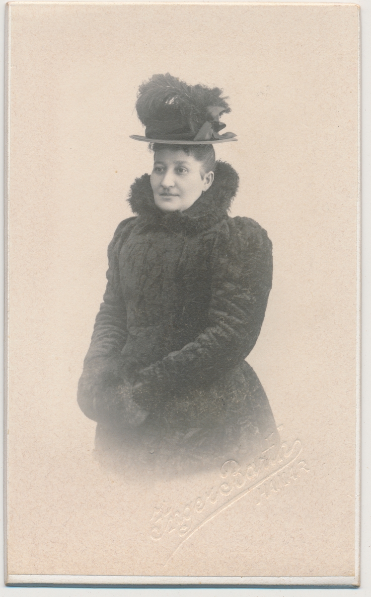 Foto av kvinne i kåpe og hatt, ukjent