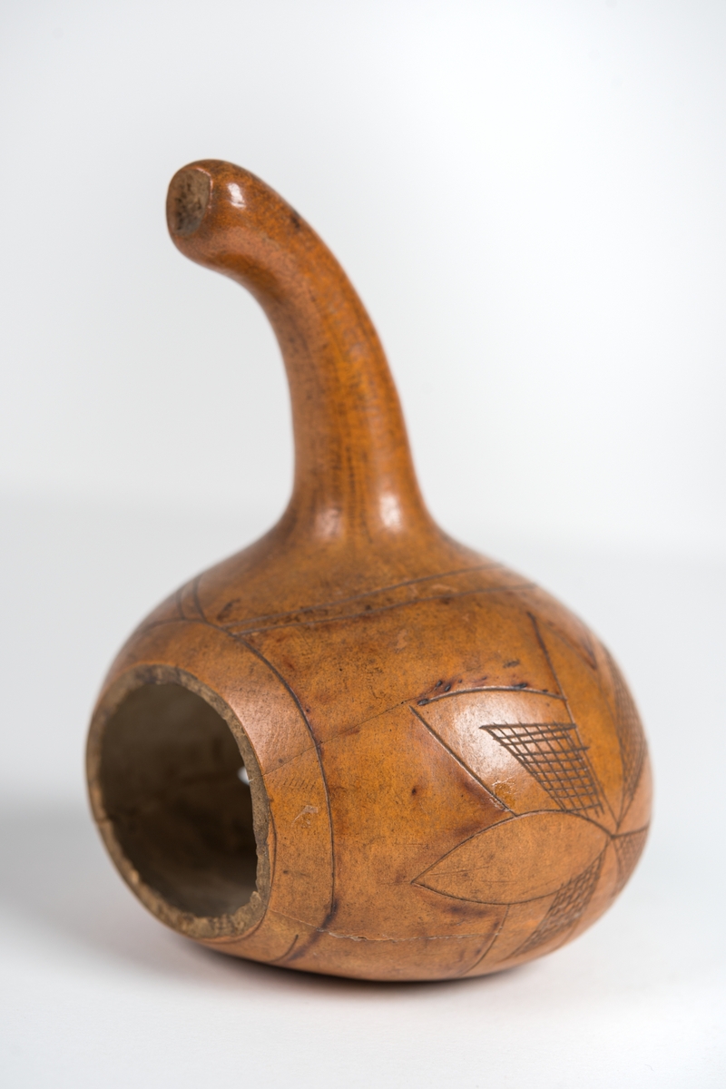 Kärl gjort av en tuktad, torkad gurka från Japan. Päronformat med stark insvängning i mitten. Litet hål upptill. Från fregatten Vanadis världsomsegling 1883-1885.