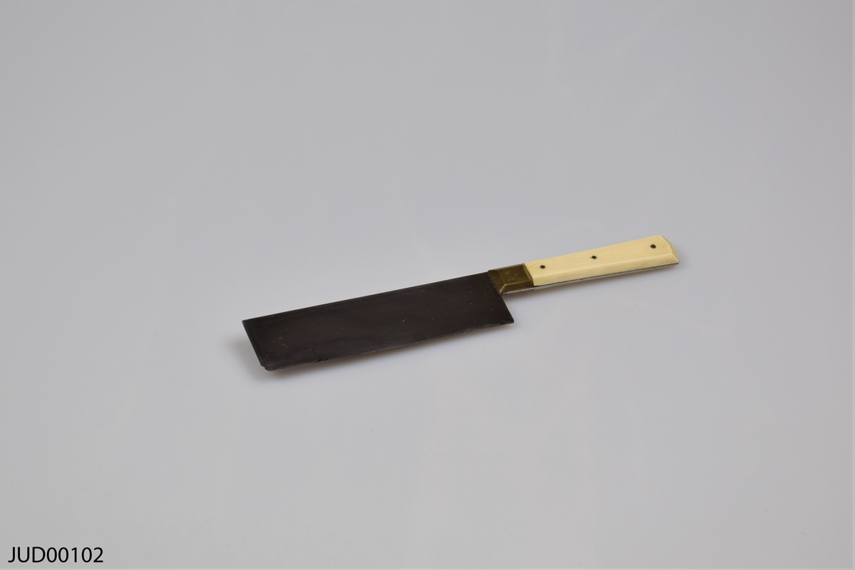 Rektangulär smal trälåda innehållandes två knivar. Knivarna har vita handtag och rektangulära blad.