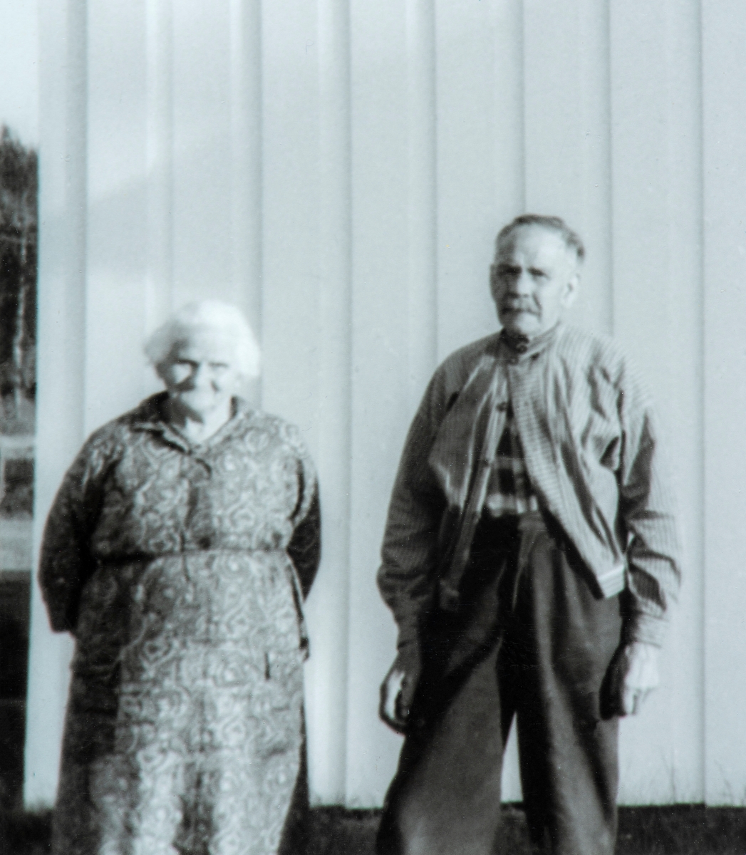 Nille (Syversdatter, f. 1889) og Markus Pedersen (f. 1885) foran Tomter skole i Vallset, hvor de bodde i kommunal leilighet fra 1968 (?) frem til sin død hhv. 03.01.1973 og 21.07.1975.