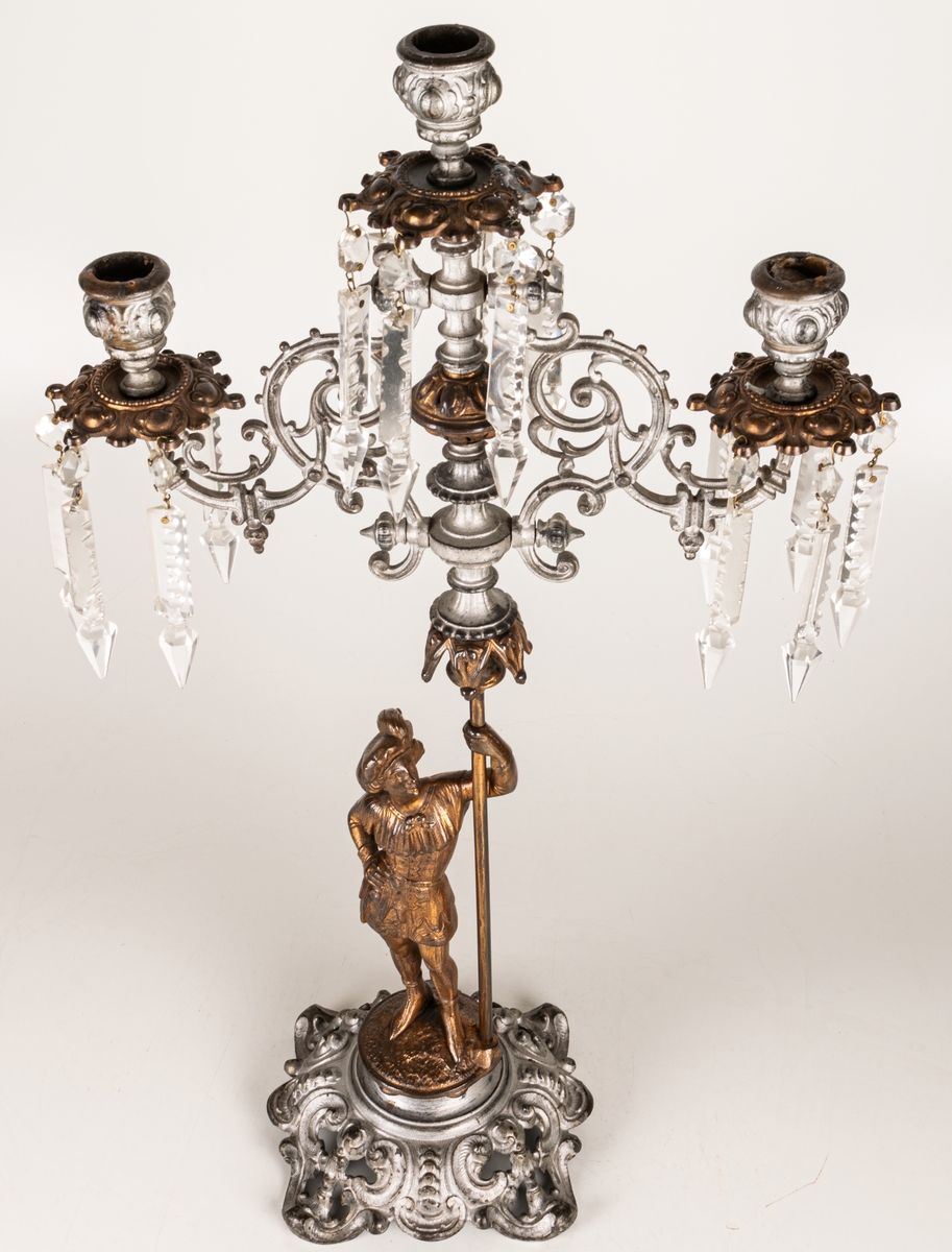 Kandelaber, en i ett par, av bronserat järn, tre ljuspipor med prismor.