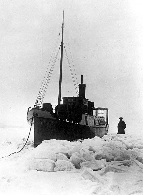 Ångfartyget Vista sitter fast i isen i februari 1905, kommer loss i april. En man står på isen intill.