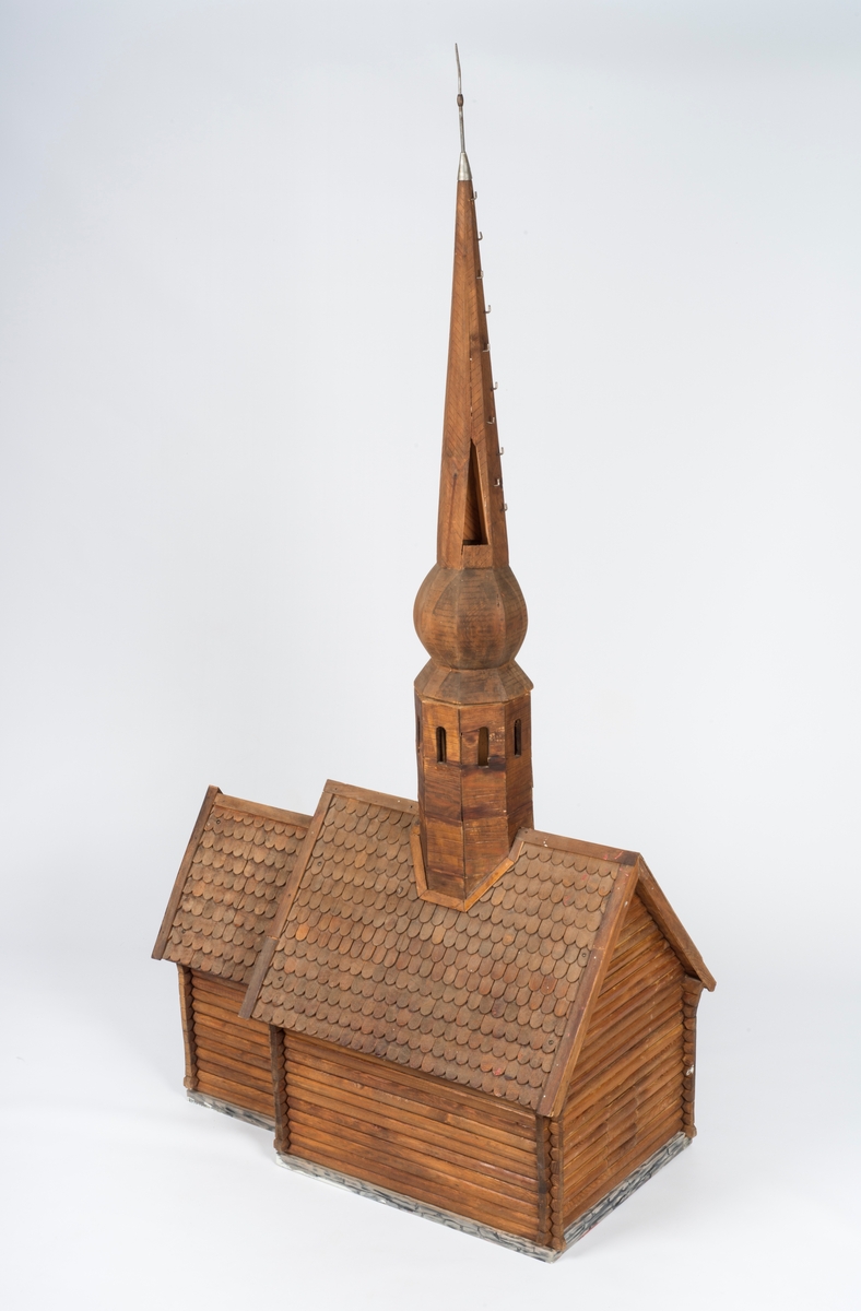 Modell av Trefoldighetskirken før påbygging av sakristi og våpenhus og påsetting av panel.

A: kirken.
B: tårnet.