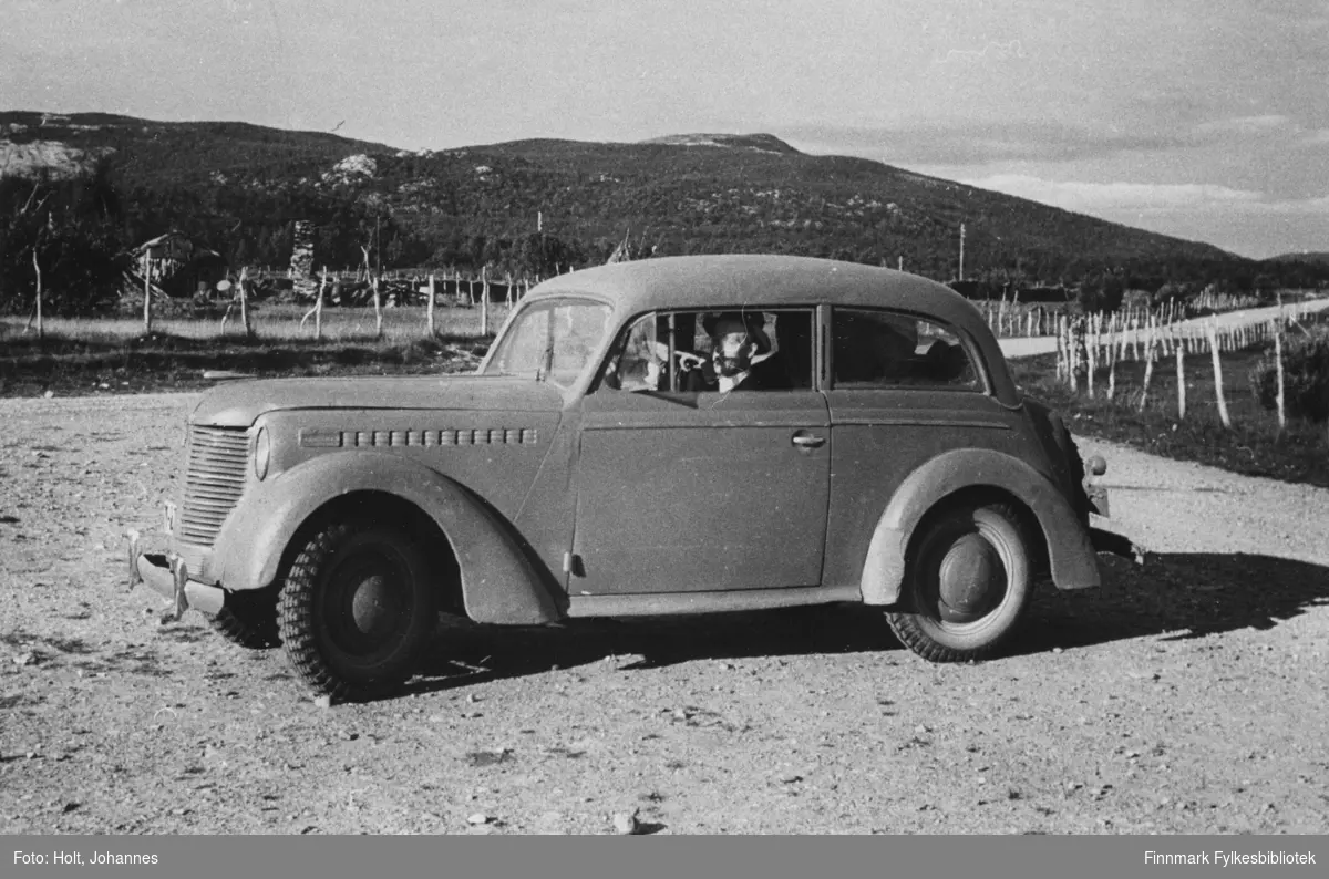 Johannes Holt i en Opel Olympia fra1938-39. Sted ukjent.