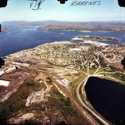 Flyfoto av Kirkenes og utover fjorden. AS Sydvaranger sitt i
