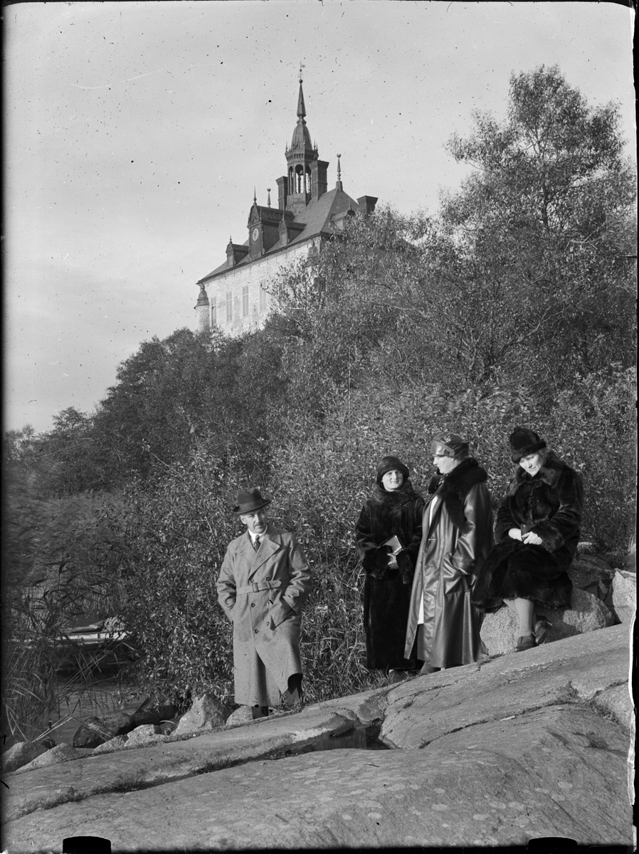 Man och kvinnor på en berghäll nedanför Wiks slott, Uppsala