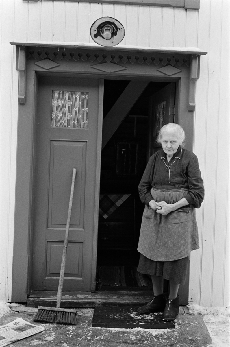 En kvinne i en døråpning på Røros.