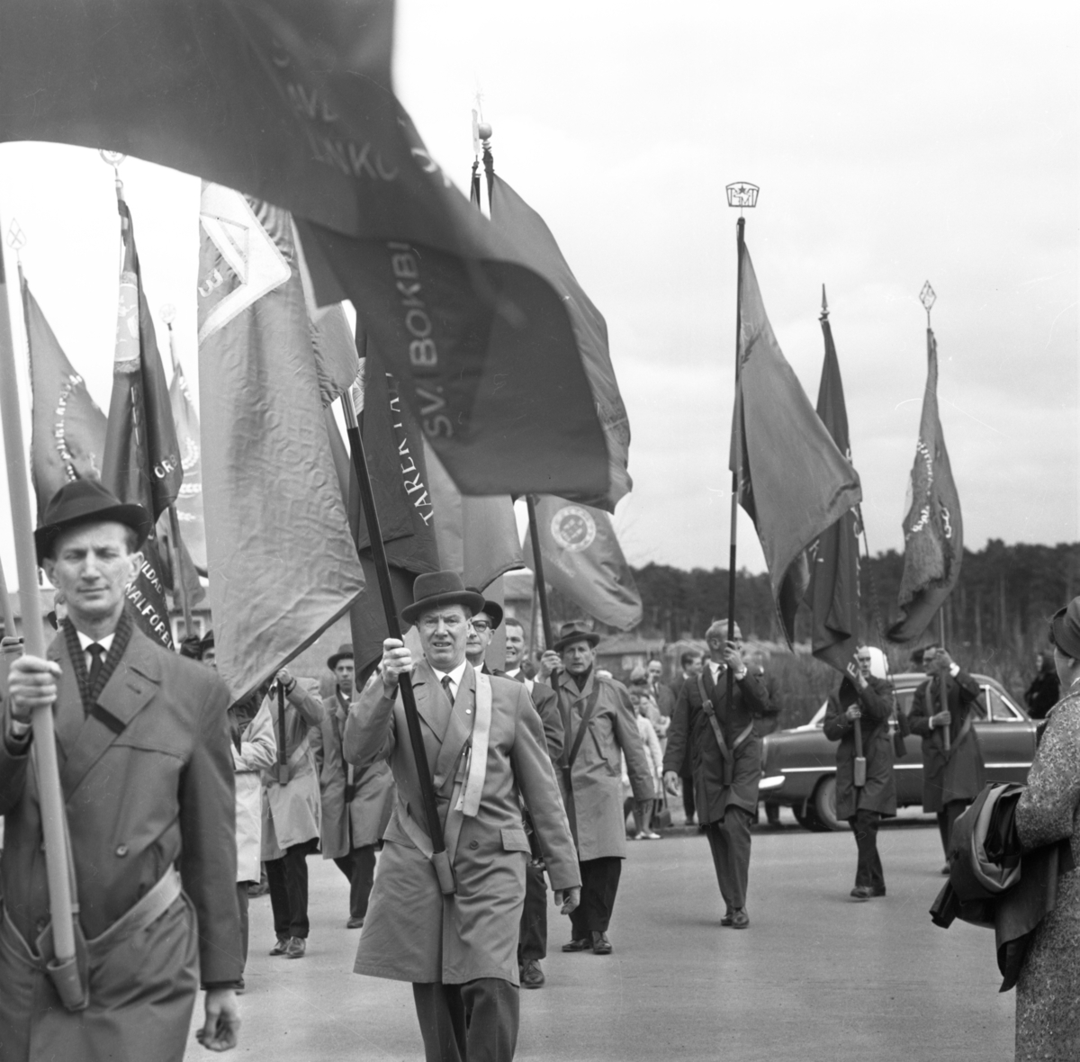 Fanbärarna samlas för avtågande. 1:a majdemonstrationen 1962.  Fanor. Demonstration. Tåg. Politik.
