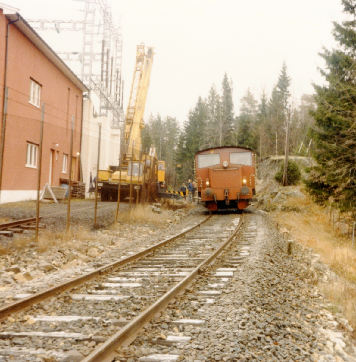 Fredag 7.11.1987. Kragerø kranservise losser en trafo  som er kommet til Holtane Trafostasjon. Denne transporten var den sist som kom på jernbanen. Senere måtte slike transporter foregå med bil og spesialhenger.  Kragerøbanen.