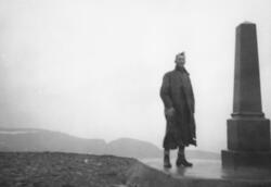 En mann står ved siden av "Oscarstøtten" på platået i Nordka
