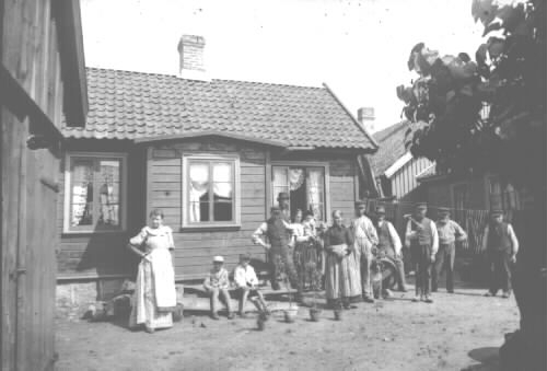 Fotot taget på J.A. Walerius gård (Gård n:o 134) vid Skolgatan år 1894 av konstnär Severin Nilson, som en tid bodde i denna gård och även var skicklig fotograf.  Personerna fr. v. Obekant dam, två pojkar, av vilka den ena är Gustaf Walerius, smedlärlingen Hugo Nöring och bakom honom Johan Adolf Walerius, hans hustru fru Hulda Walerius (f. Nöring) med sonen Ernst (2 år gammal), en pojke, fru Sabina Walerius ( f. falk), en stenhuggare (med hund), timmermannen Johan Elof Stenbeck (då ägare till granngården), en stenhuggare, en snickare vid namn Petter Johan, och längst till höger J. Gottlieb Walerius.  (Johan Adolf Walerius och Gustaf Walerius var söner till J. Gottlieb Walerius och hans hustru Sabina.) (A.S.)