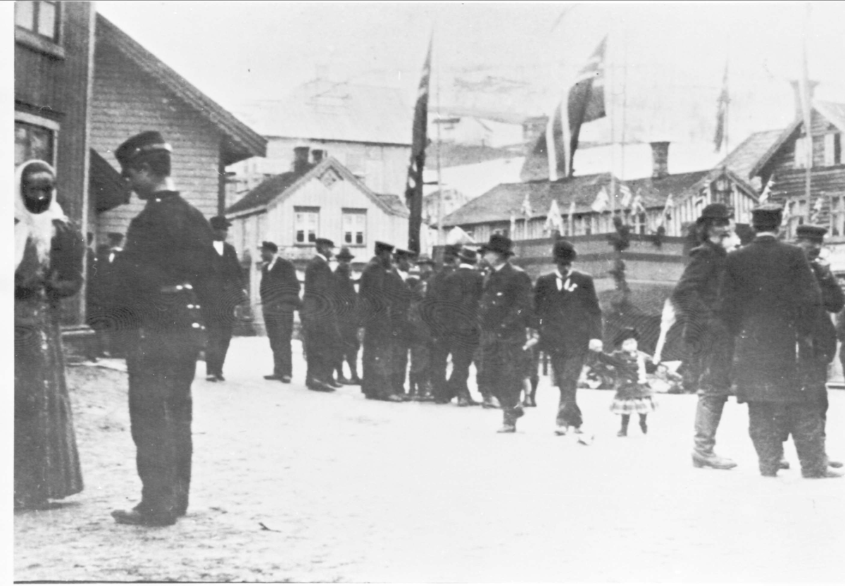 Folk på St. Olavs plass på 17. mai. Til venstre i forgrunnen en soldat i samtale med kvinne.