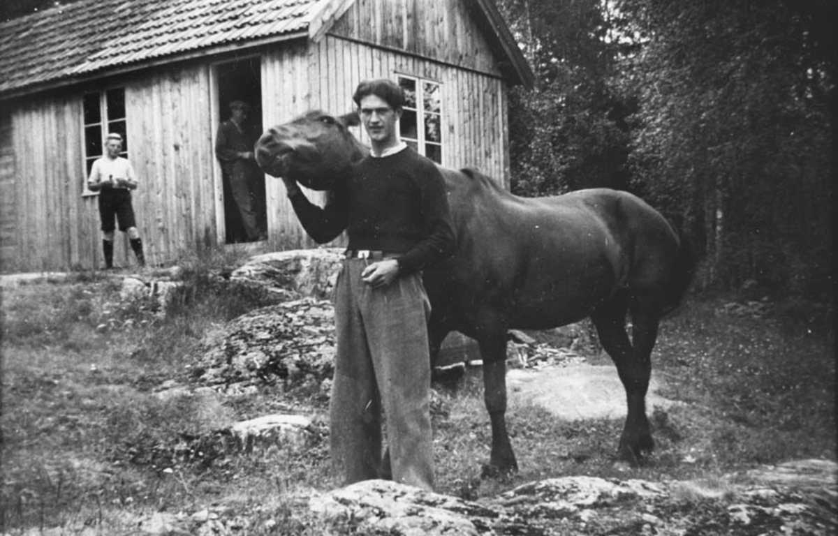 Mann og hest på gårdstun (Kåre Høybråten f. 1911).
