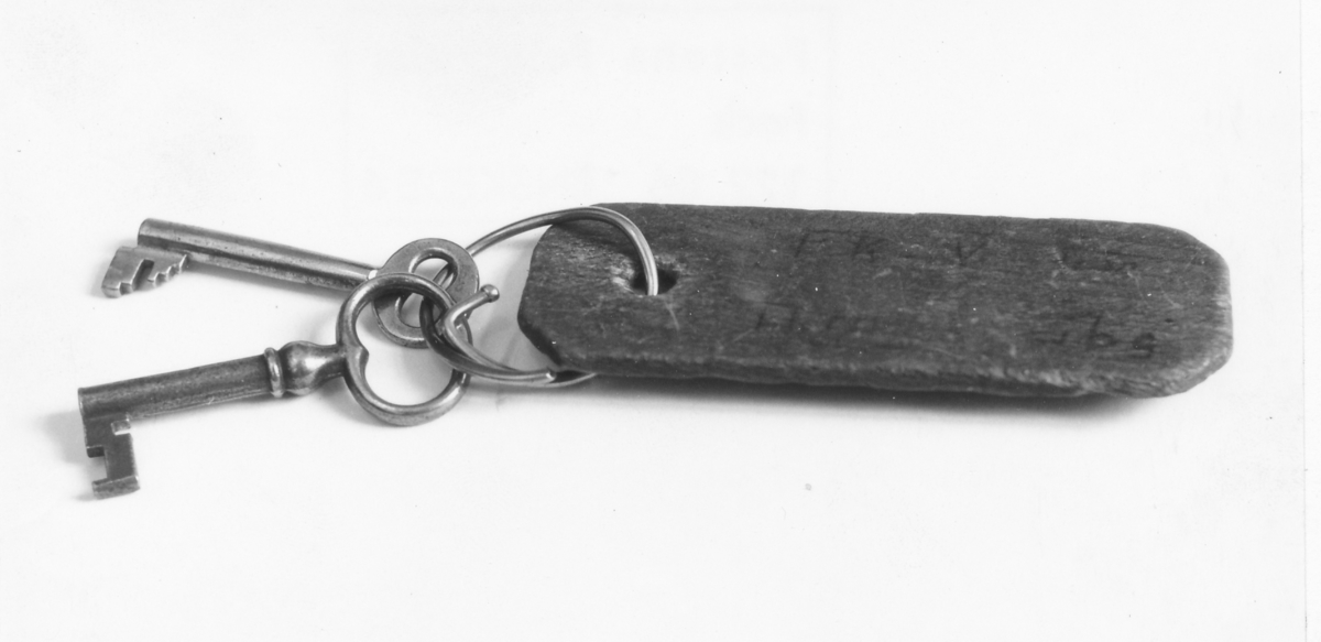 Nycklar, två stycken på en nyckelring med reklangulär träbricka på vilken står texten: FK V från Thtn Gbg.