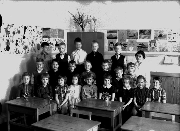 Almby Östra skola, klassrumsinteriör, 21 skolbarn med lärarinna fröken Karin Ohlsson.
Klass 1af, sal 6.