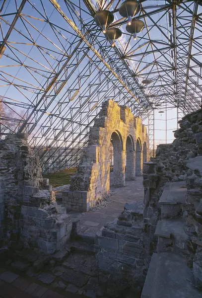 The medieval arches are lit up by the morning sun, and the ruins are almost shining under the glass ceiling.