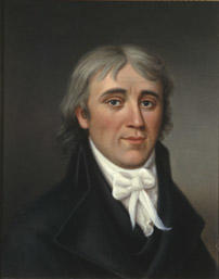 Portrett av Hans H. Nysom. Mørk drakt, hvit skjorte og halsbind.