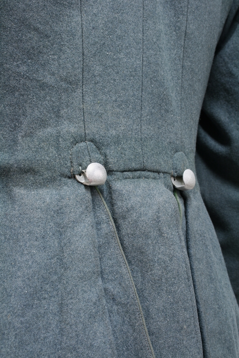 Full uniform med støvler. På brystet har den en pins (Politiets dag 1942), en bånd (Minne-/deltakermedalje 1914-1918) og EK. 2. klasse bånd. Den har også fløyte i brystlommen. 

Skulderdistinksjoner til en oberwachtmeister

I lommen var det stoff lapper og sytråd med nål. 

På beltet har den pistolhylster med Walther PP magasin.