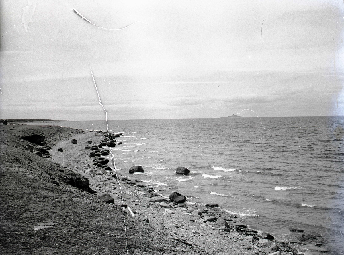 Vy vid kusten med bukten till vänster på Öland. Blå Jungfrun i fjärran.