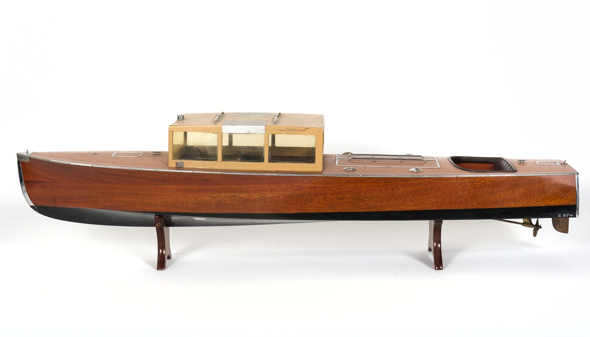 Fartygsmodell av motorbåt av den så kallader skärgårdsdroskan PLYM-ÅTTA konstruerad av Carl Plym för Stockholmsutställningen 1930. Förpikslucka midskepps, salong med nio fönster och akterut ett sittrum med soffa. 
Modellen har ett fast skrå undertill.