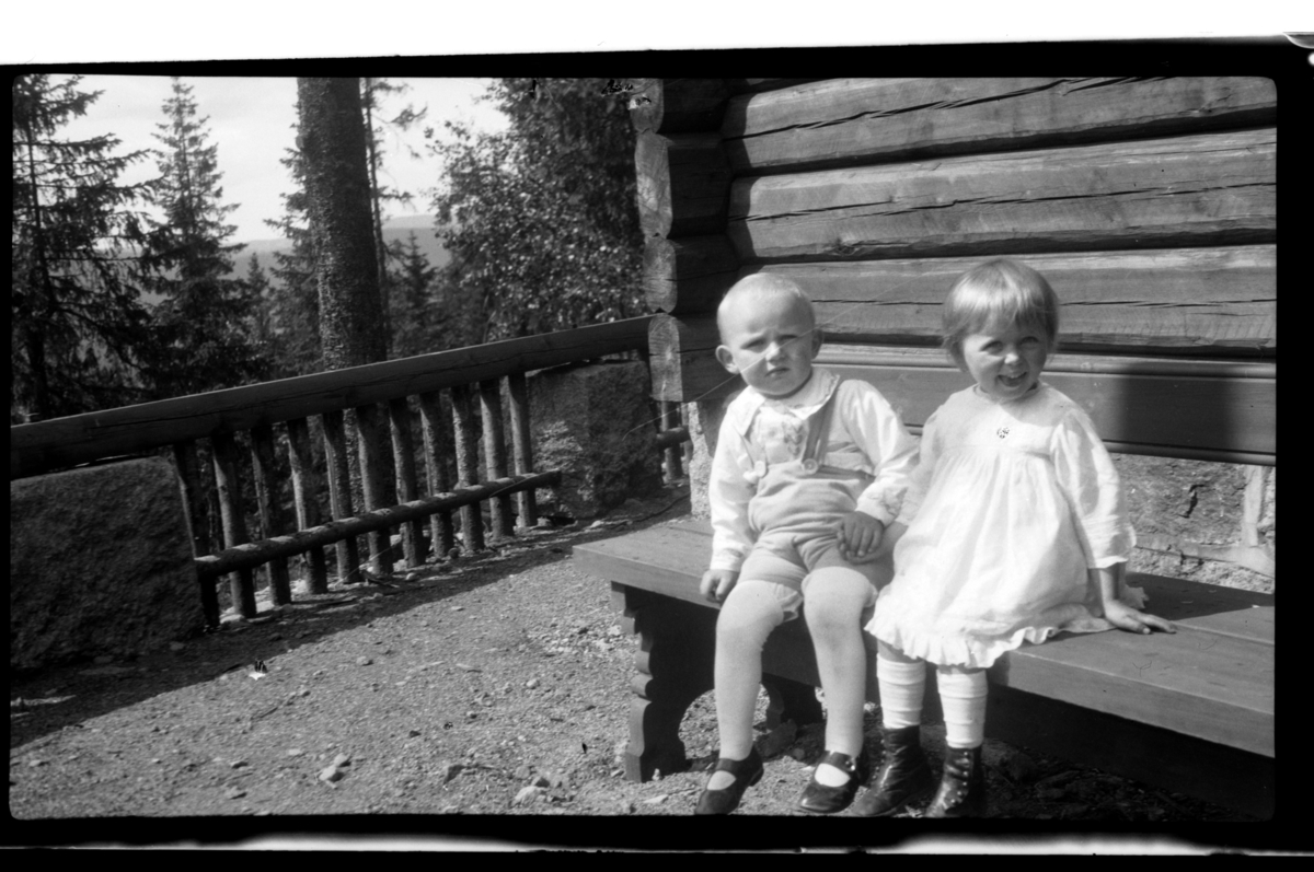 Julius Sundt sitter sammen med sin kusine Elsa Sundt på en benk, Villa Knyggen. Fotografert 1919.