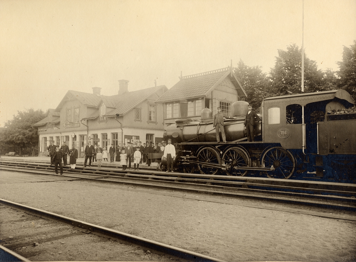 Lok litt T med personal samt stationspersonal framför Tumba stationshus 1901. Loket är SJ T 756. Nils Nilsson, stins i Tumba 1896-1903.