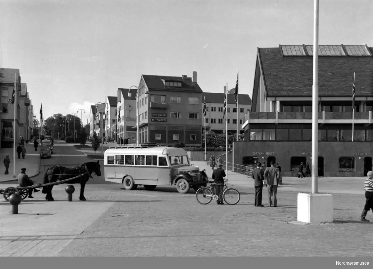 Foto fra Kaibakken på Kirkelandet i Kristiasund, med blant annet en buss og hest og kjerre på bildet. Fotograf er Nils Williams. Fra Nordmøre museums fotosamlinger.