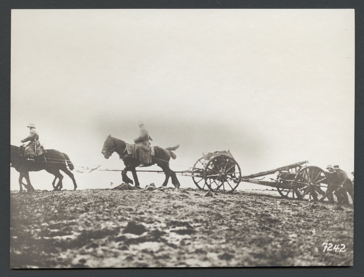 Bilden visar en hästdragen artilleripjäs som dras av en grupp Soldater över en sönderbombad slagfält.

Originaltext: "Tyskt artilleri på frammarsch över slagfältet."