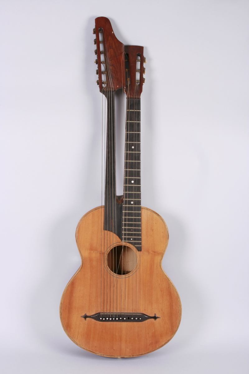 Gitar med dobbel hals. En hals med bånd og 6 strenger, 6 løssvingende strenger ved den andre halsen.