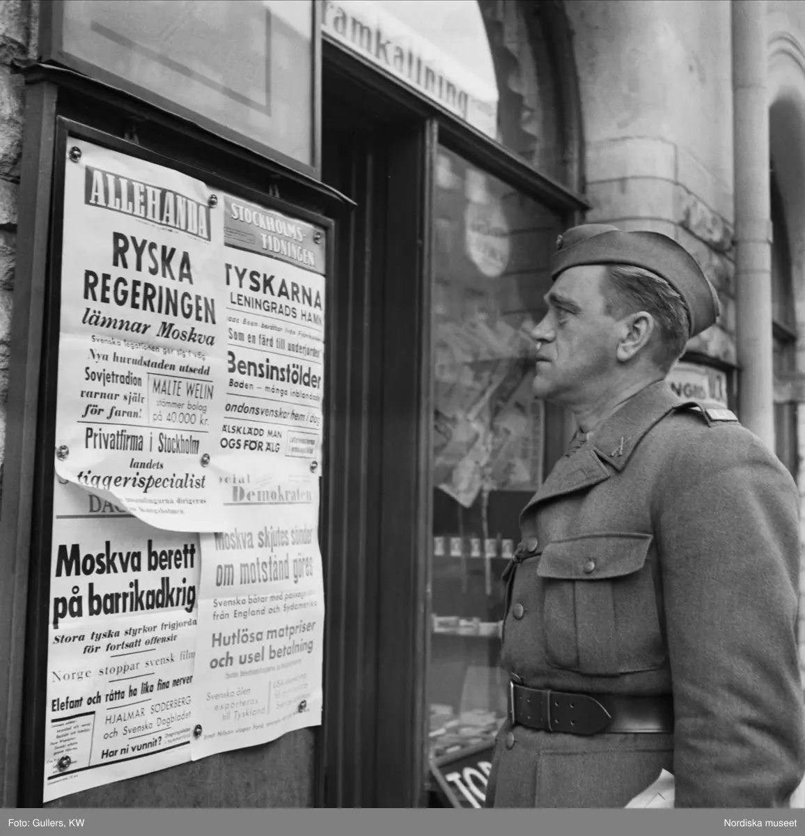Författaren Wilhelm Moberg läser löpsedlar om kriget.