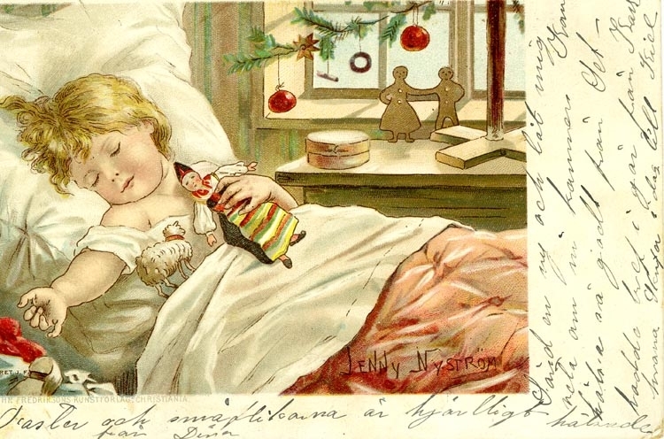 Julkort. Ett  sovande barn i sin säng med några av sina julklappar