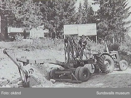 Elverkets första grävmaskin, driven fr. traktorns kraftuttag. Ur fotoalbum från Sundsvalls Energi.