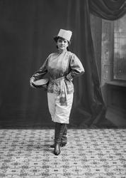 Skuespiller i kosakk-kostyme med tamburin.  Kan være Signe H