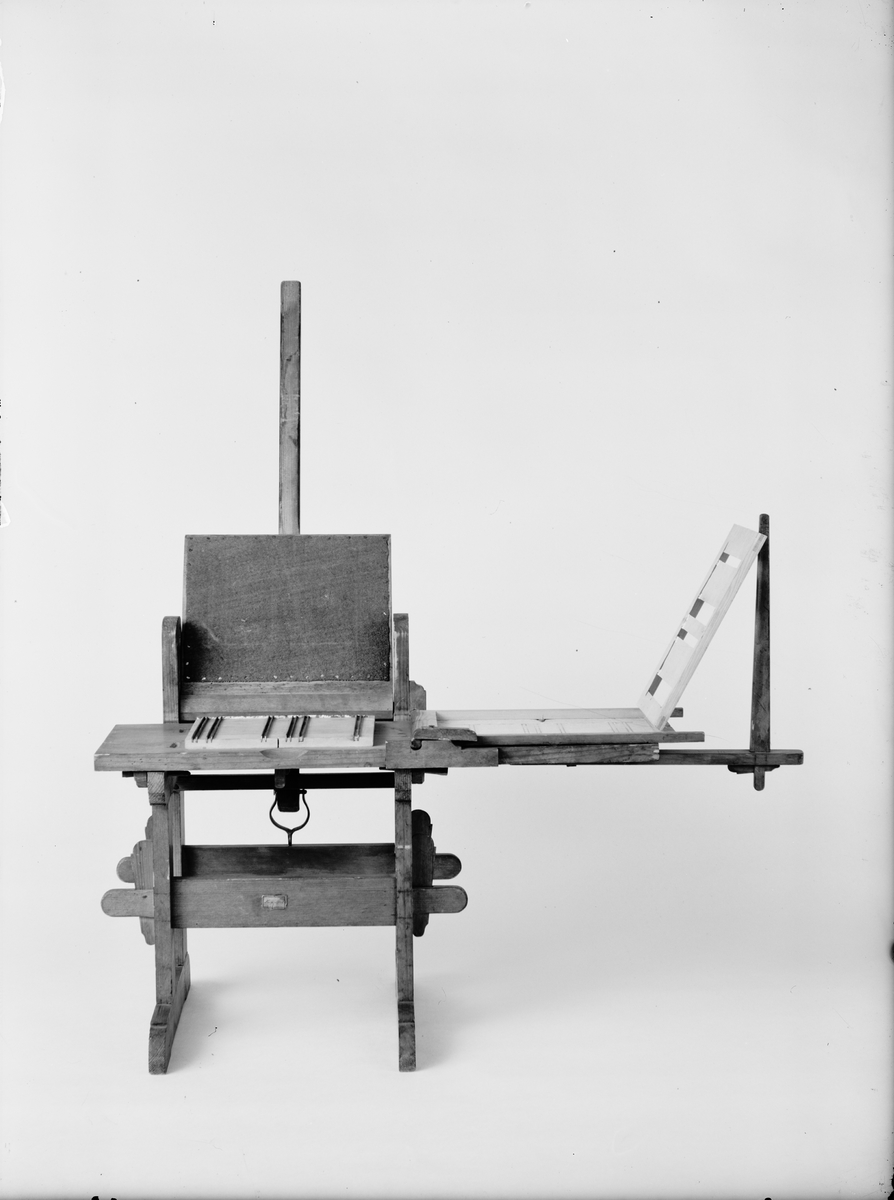 Modell av press för linjering av papper. Text på föremålet: "N:o 180. F-a-g-2 XIII. 25" (texten delvis försvunnen).