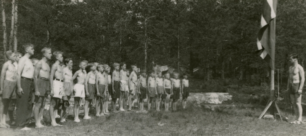 Saluting the flag, camp for boys first year of occupation