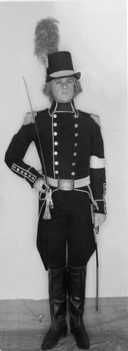 Beklädnad och beväpning till sjöofficersuniform 1808.
Stärkkrage, vit, upprättstående. Märkt: "NV" inom  lagerkrans samt  "Fashion 40."