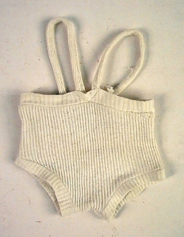 Vita, korta byxor i bomullstrikå med hängslen till babydocka. 
Konfektion