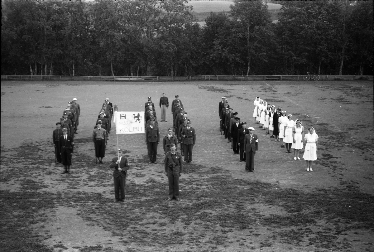 Milorggruppa på Kolbu (HS1432-4), samt lotter, oppstilt på Kolbu Idrettsplass, trolig i forbindelse med et arrangement i anledning Milorgs demobilisering i juli 1945. Tre bilder.