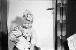 Uidentifisert jentunge med dukke. Fire bilder.