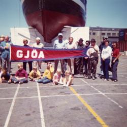 Gruppe med mennesker på parkeringsplass foran 'Gjøa' før hje