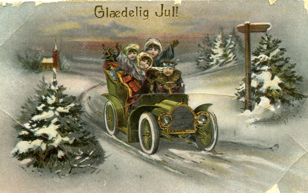 Julekort. Vinterlandskap. Tre jenter og en gutt kjører åpen bil lastet med gaver og juletre. Kirke i bakgrunnen. Deler av motivet er forgylt. Stemplet 24.12.1919.