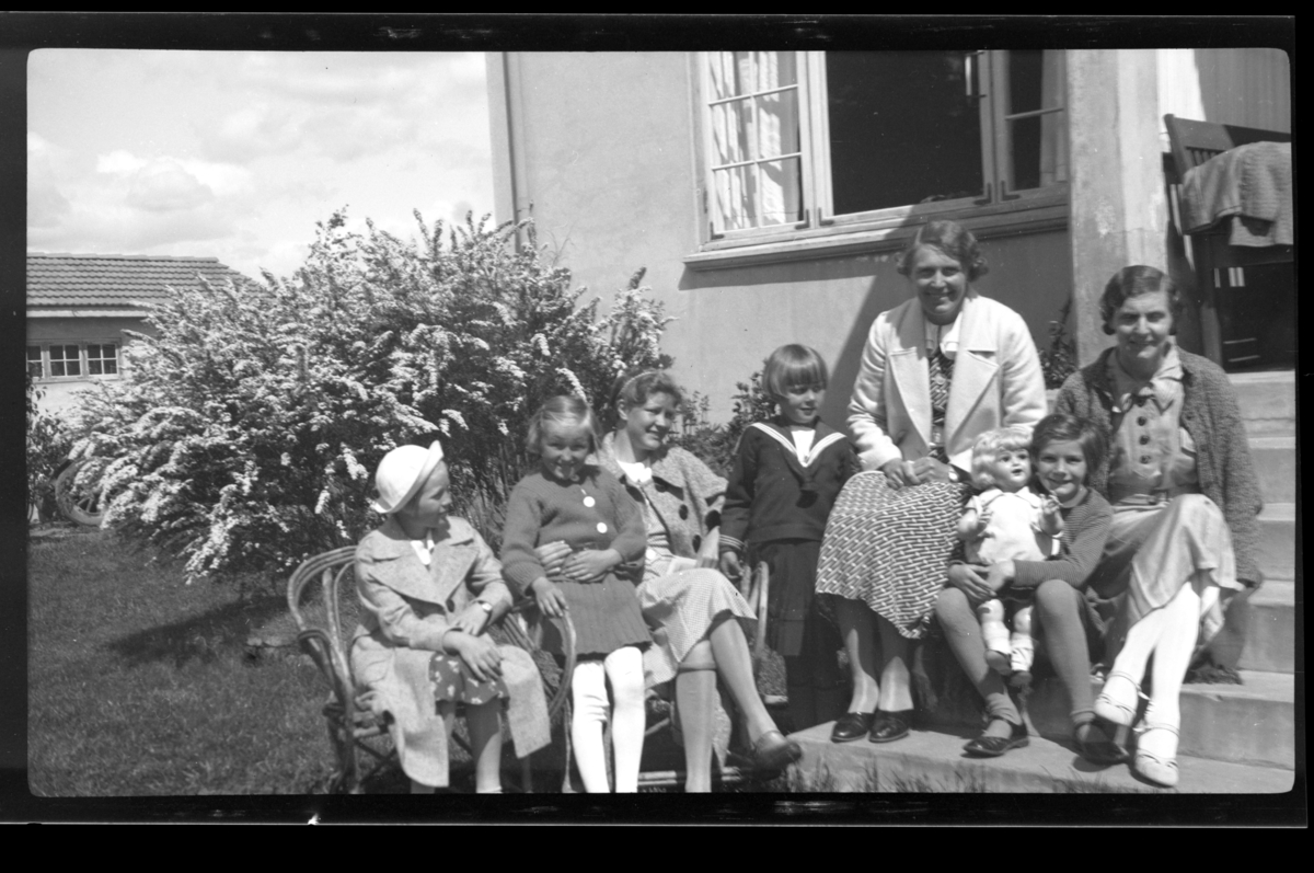 To ukjente barn, Anne Lise Hansen, hennes mor Betsy Aubert Hansen og søster Elisabeth Hansen står sammen med Betsys søster Hilda Sundt på en trapp, Herøya. Fotografert 1936.