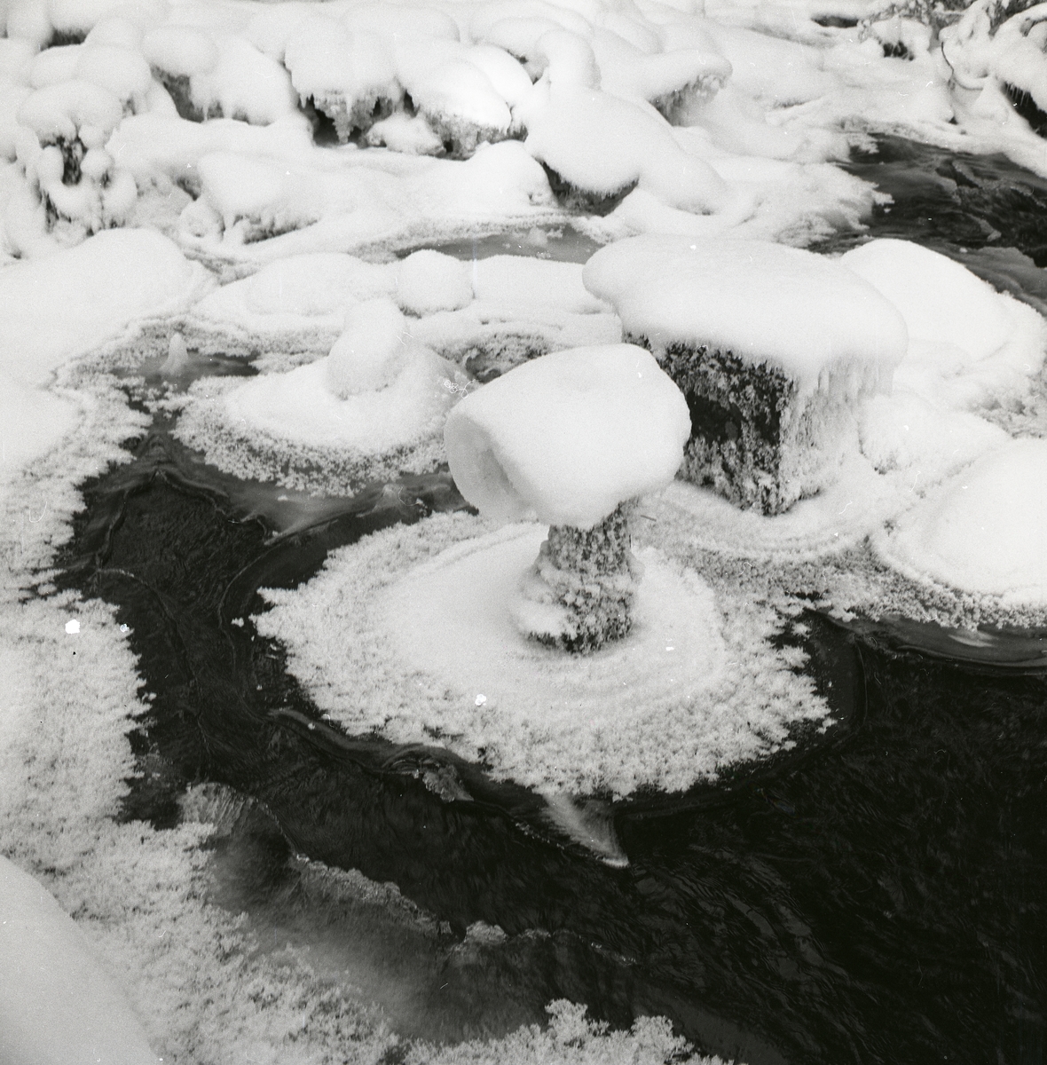 Snötäckta stenar intill vattenfallet vid Hyttkvarnån den 14 december 1959.